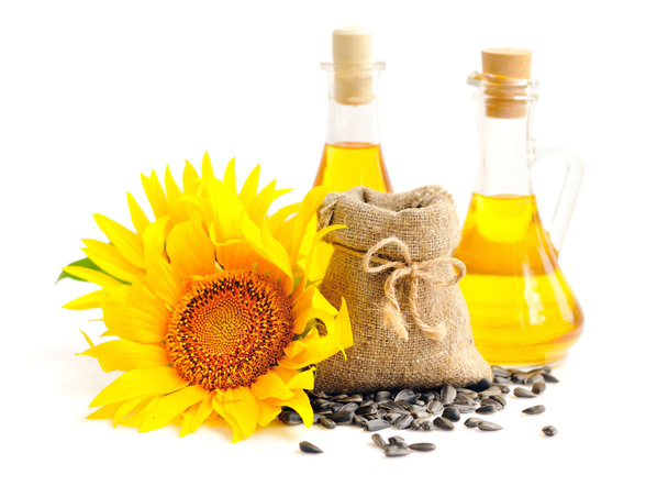Saco pequeno com sementes e flores de girassol e uma garrafa de óleo de girassol
 - Foto, Imagem