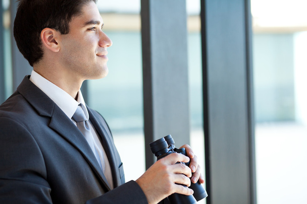Ambitious young businessman with binoculars - Zdjęcie, obraz