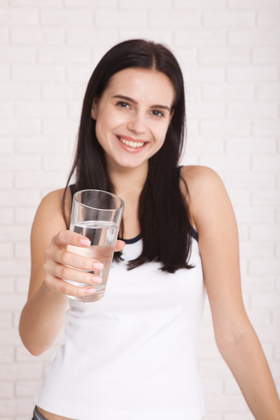 Girl drinking water at home. Glass of water in morning before breakfast. - Photo, Image