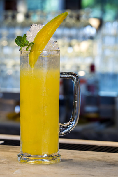 beautiful frozen yellow cocktail glass at bar counter - Fotó, kép