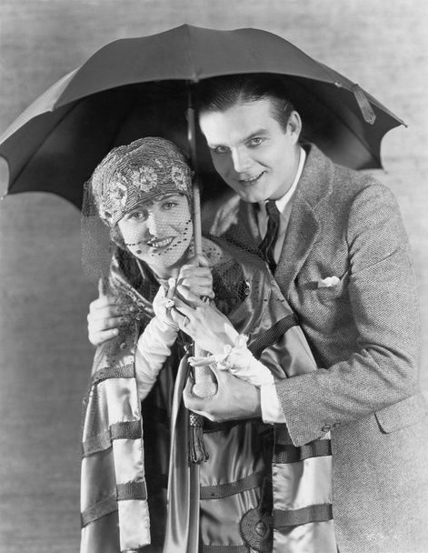 Portrait of couple under umbrella - Photo, Image