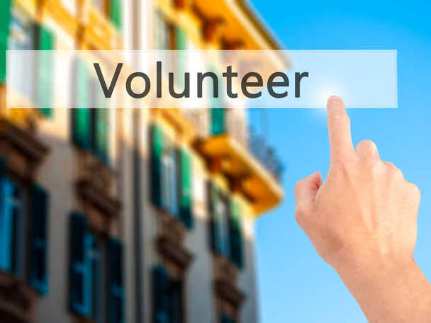 Gönüllü - Bulanık arka plan konseptinde düğmeye basarak el - Fotoğraf, Görsel