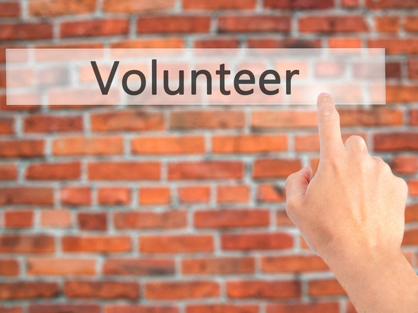 Volunteer - Hand pressing a button on blurred background concept - Fotó, kép