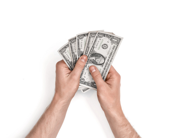 Hands of man holding one-dollar bills on white background. - Foto, Imagem