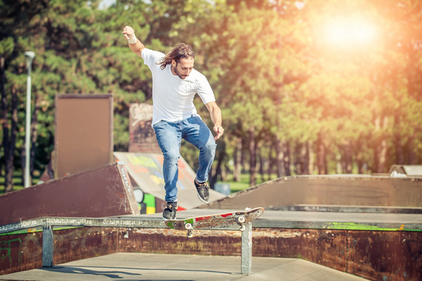 Skater jumping in skateboard park - Фото, изображение