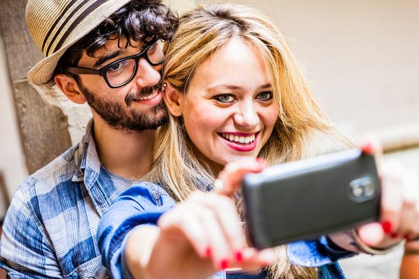 Smiling young couple taking selfie - Фото, изображение