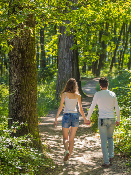 young couple walking in forest - Foto, Bild