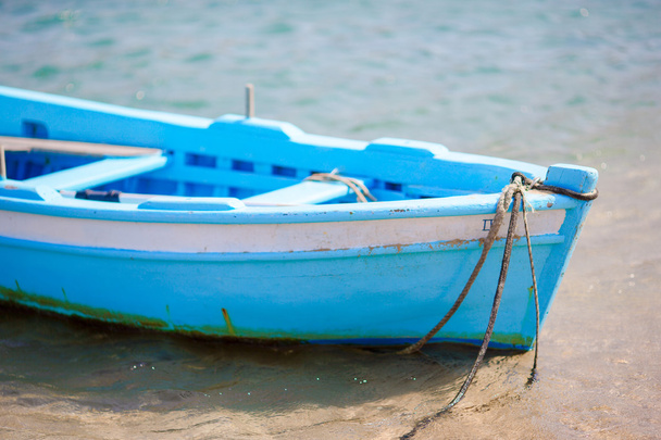 Typical blue and white color Greek fishing boat in Mykonos port on island of Mykonos, Cyclades, Greece - Photo, Image