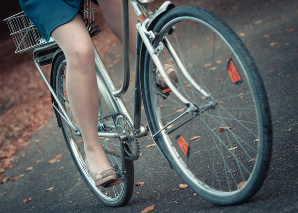 Girl in dress on bike. - Foto, Imagen