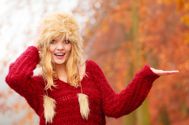 Pretty smiling woman in fur hat with copy space. - Zdjęcie, obraz