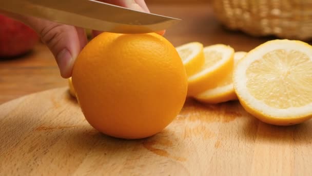 Hands cutting fresh orange - Filmati, video