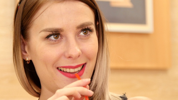 beautiful girl drinks juice through a straw - Footage, Video