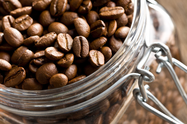 Coffee beans in glass jar - Фото, изображение