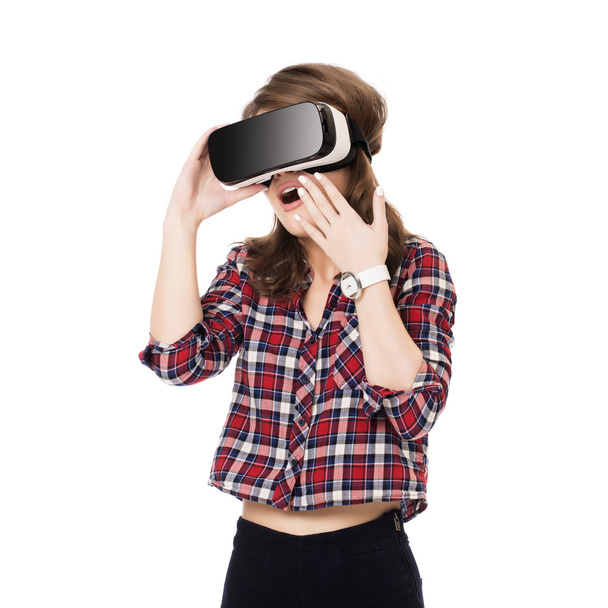 Happy girl getting experience using VR headset glasses of virtual reality, much gesticulating hands, isolated - Photo, image