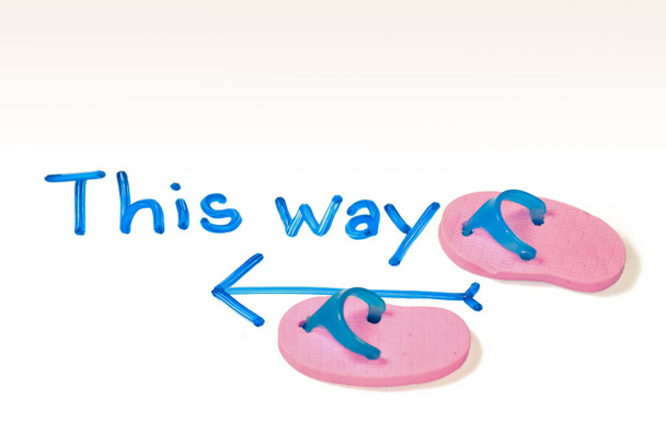 Miniature rubber slippers with wording This way, Concept - Photo, Image