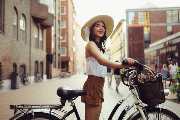 Attractive woman using bicycle - Foto, afbeelding