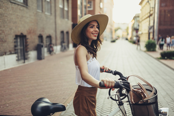 Beautiful woman using bike - Фото, зображення