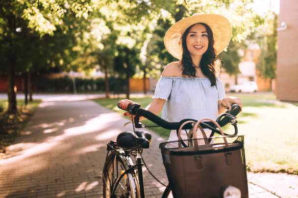 Beautiful woman using bicycle - Photo, image
