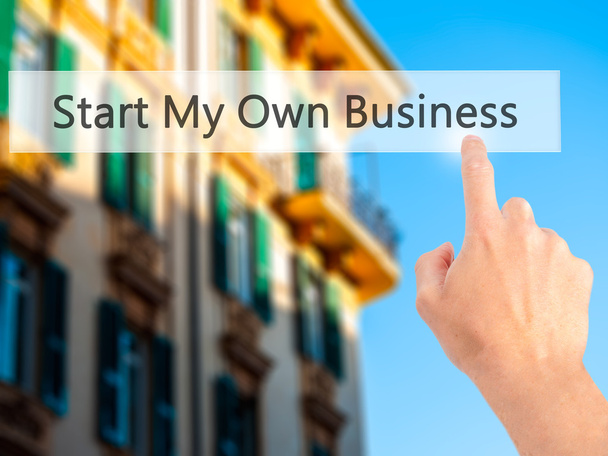 Start My Own Business - Hand pressing a button on blurred backgr - Foto, Bild