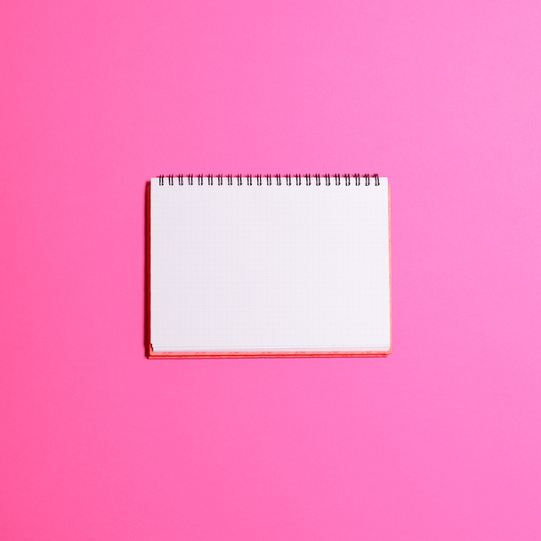 Blank notebook page on pink background  - Flat lay - Φωτογραφία, εικόνα