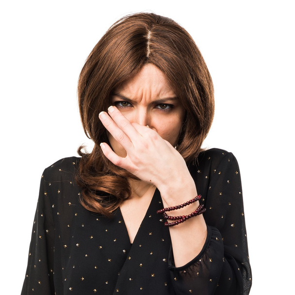 Woman making smelling bad gesture - 写真・画像