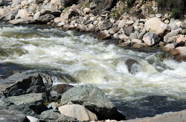 The rapid flow of a mountain river. Photo partially tinted. - Photo, Image