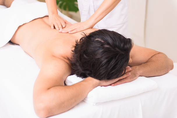 Relaxed man getting massage at spa - Photo, Image