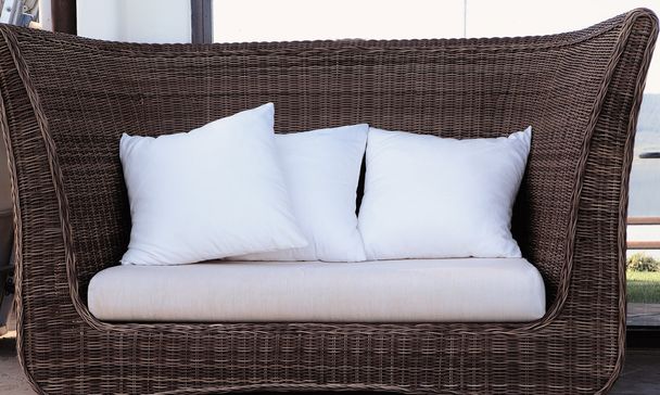 rattan wicker sofa with pillows - Фото, изображение