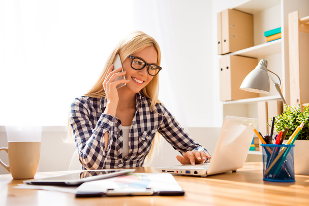 Happy successful woman in glasses talk phone and work laptop  - Photo, image