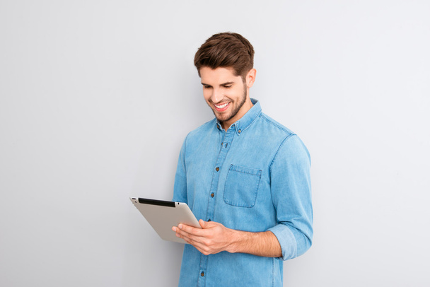 Handsome man using digital tablet on gray background - Φωτογραφία, εικόνα