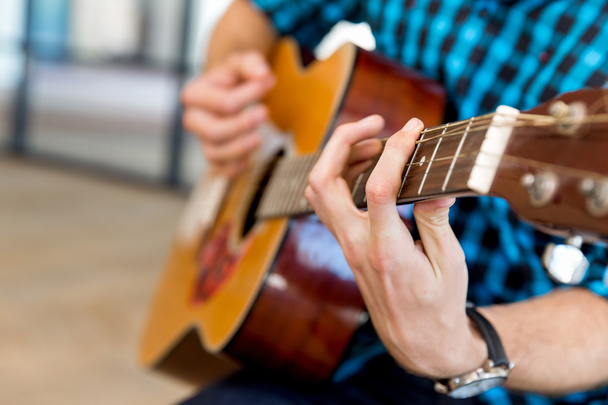 Man playing guitar in office - Photo, Image
