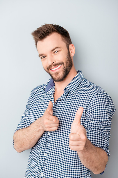 Cheerful happy smiling businessman gesturing and pointing on cam - Foto, Bild