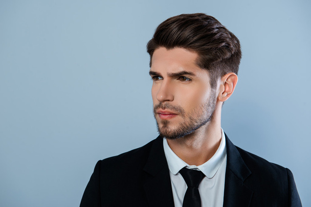 Portrait of handsome harsh man with bristle in black suit - Photo, image