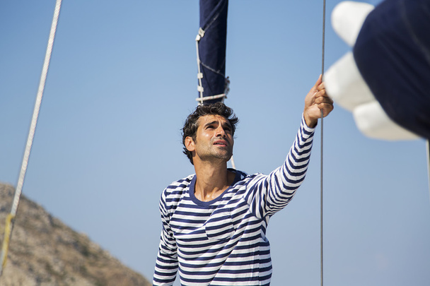 Young man on sailboat - Photo, Image