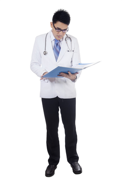 Doctor reads medical record document - 写真・画像