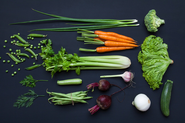 Collection of fresh summer vegetables on black rustic background - 写真・画像