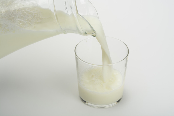 Pouring milk in a glass - Zdjęcie, obraz