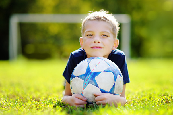 Little boy having fun playing a soccer game - Photo, image