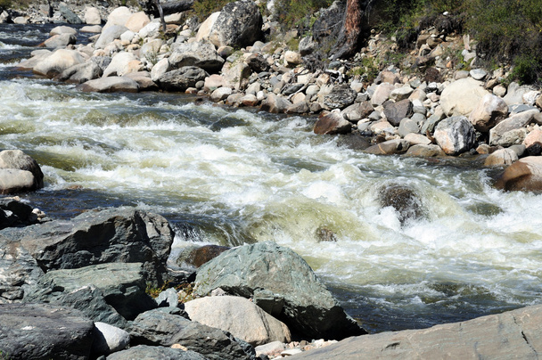 The rapid flow of a mountain river. Photo partially tinted. - Photo, Image