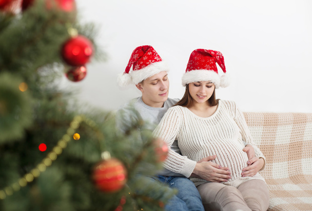 happy couple with Christmas tree indoor - Foto, Imagem