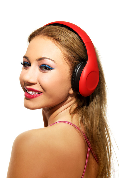 Party woman with headphones listening to music. - Valokuva, kuva