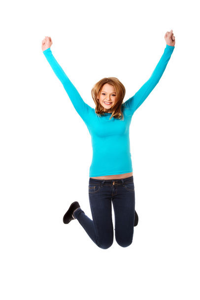 Young woman jumping with joy - Φωτογραφία, εικόνα