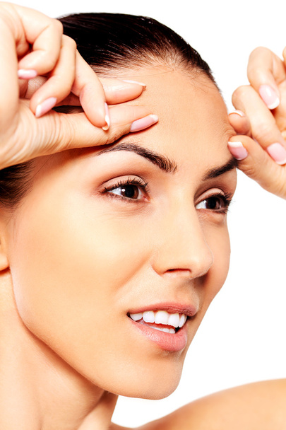 Worried young woman checking wrinkles on forehead - Φωτογραφία, εικόνα