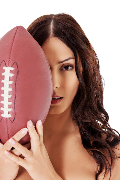 Beautiful nude woman holding american football ball. - Φωτογραφία, εικόνα