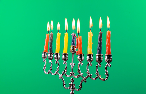 Hanukkah menorah with candles green background isolation - Photo, Image