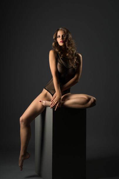 Erotica. Sexy woman in bodysuit posing at camera - Фото, зображення