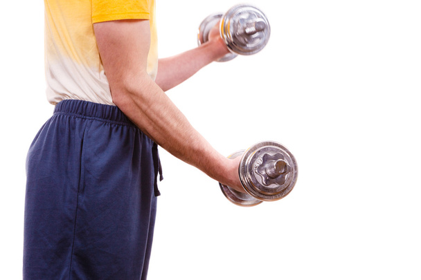 Man exercising with dumbbells lifting weights  - Foto, Imagem