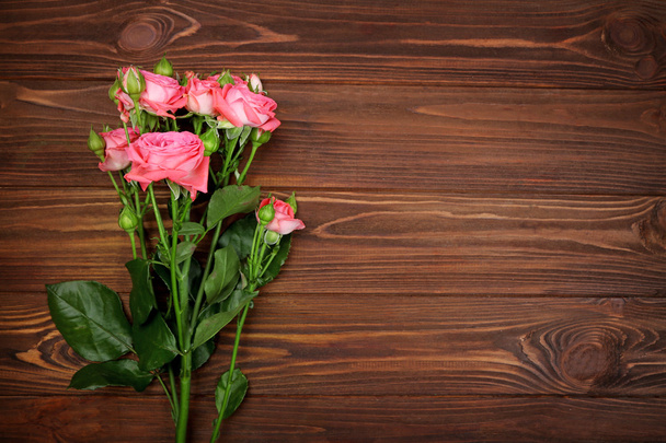 Fresh flowers on  wooden background - Foto, Bild