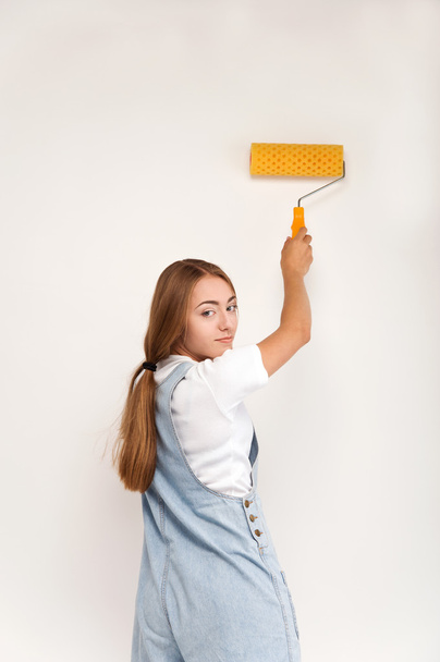 young girl holding a paint roller - Photo, Image