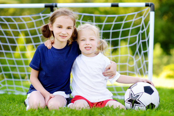 sisters playing a soccer game - 写真・画像